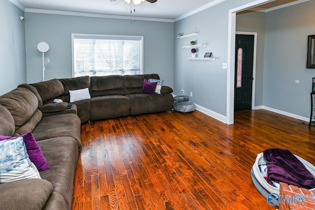 living area featuring ceiling fan, ornamental molding, dark wood-type flooring, and baseboards