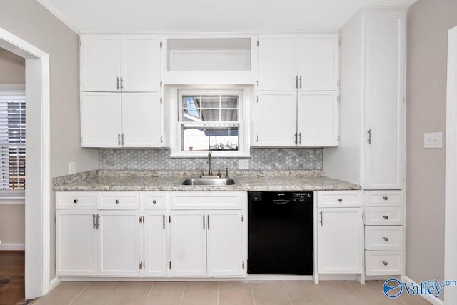 kitchen with black dishwasher, a sink, and white cabinetry