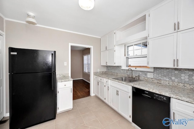 kitchen featuring black appliances, white cabinetry, and a sink