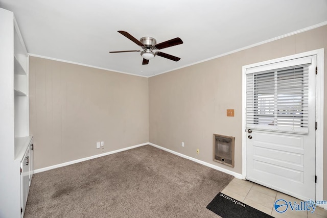 spare room with crown molding, light colored carpet, a ceiling fan, and heating unit