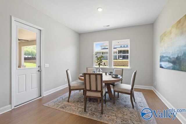 dining area featuring wood finished floors and baseboards