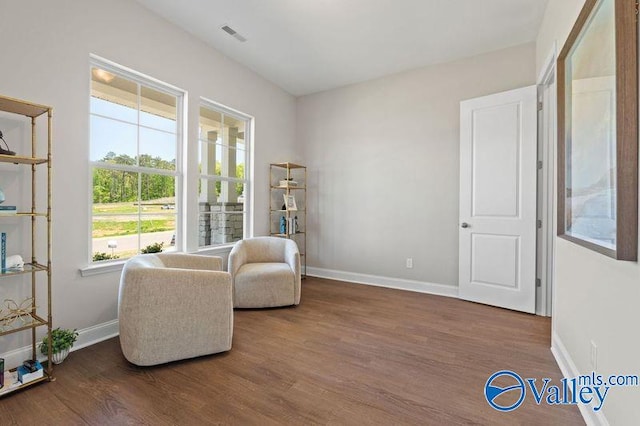 sitting room featuring wood finished floors, baseboards, and visible vents
