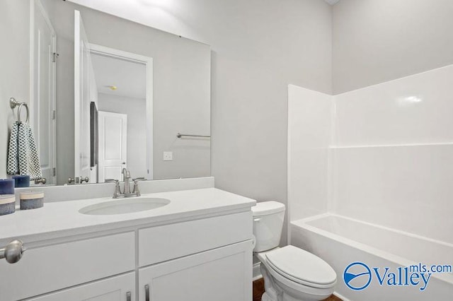 full bath featuring vanity, toilet, and shower / washtub combination