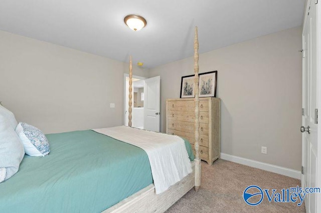 carpeted bedroom featuring baseboards