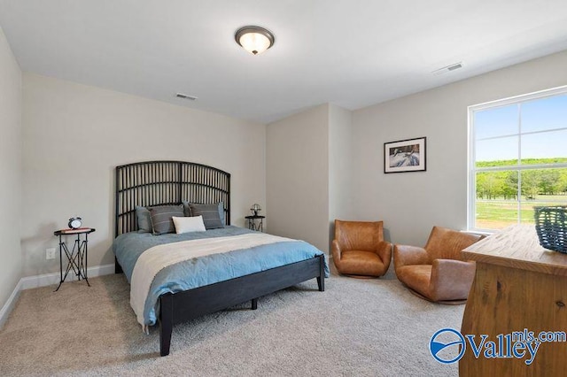 bedroom with visible vents, baseboards, and carpet flooring