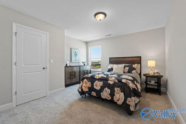 bedroom with visible vents, baseboards, and carpet