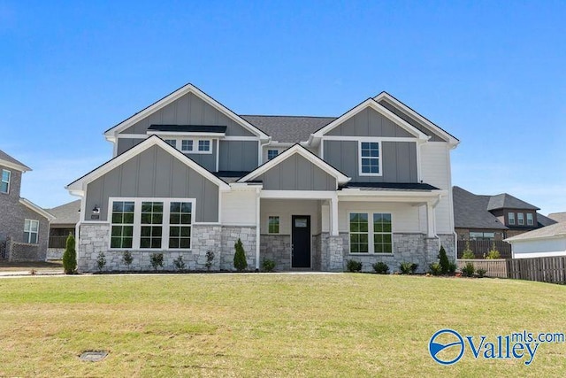 craftsman-style home featuring board and batten siding, a front yard, and stone siding