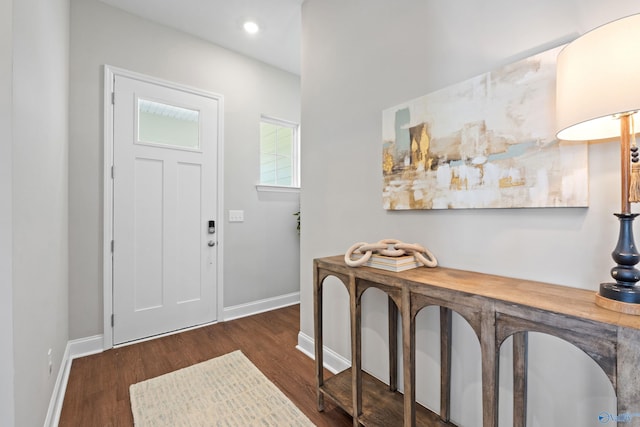 foyer featuring baseboards, recessed lighting, and dark wood-style floors