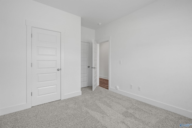 unfurnished bedroom featuring baseboards and carpet flooring