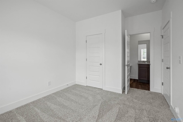 unfurnished bedroom with carpet and baseboards