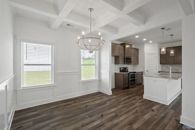 kitchen with light stone counters, stainless steel appliances, visible vents, hanging light fixtures, and a sink