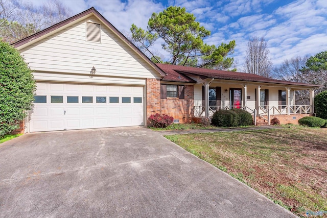 ranch-style house with a front lawn, covered porch, and a garage