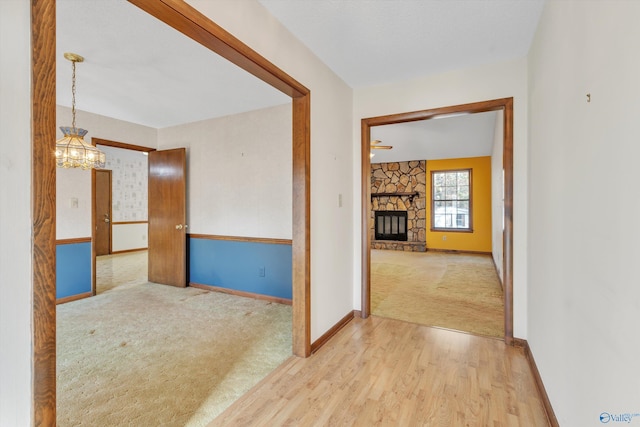 corridor featuring carpet floors and a chandelier