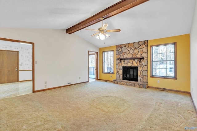 unfurnished living room with ceiling fan, light carpet, a stone fireplace, and a healthy amount of sunlight