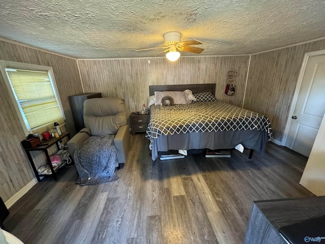 bedroom featuring a textured ceiling, dark hardwood / wood-style floors, ceiling fan, and wood walls