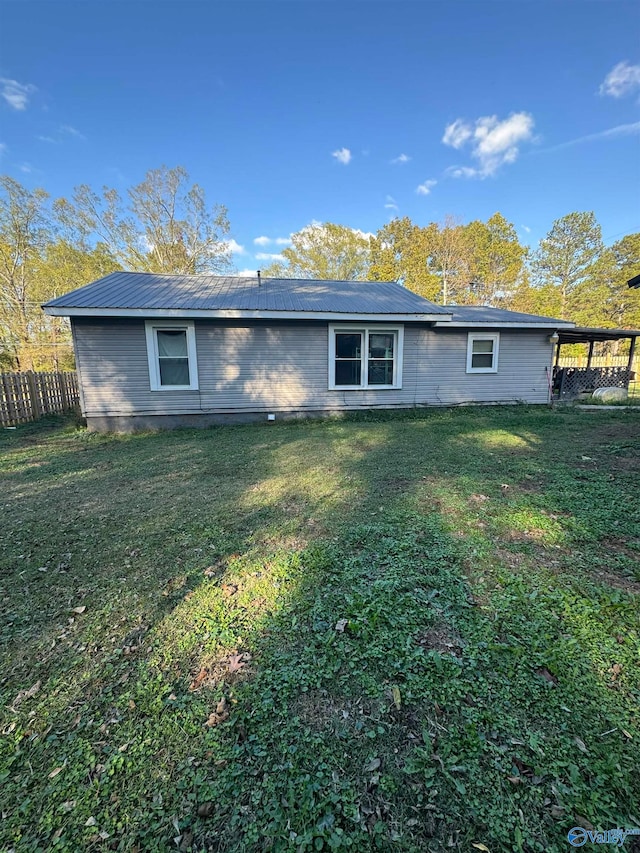 rear view of property with a lawn