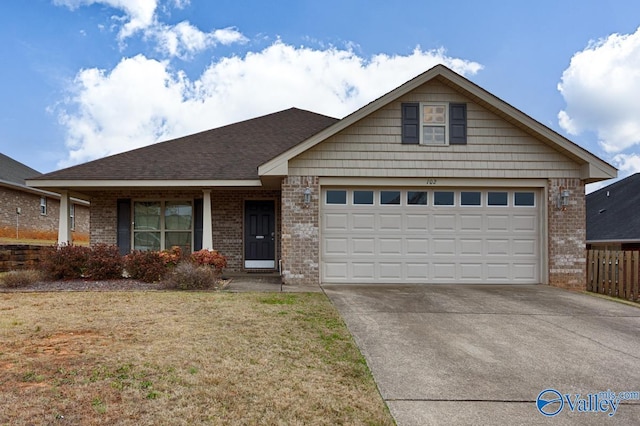 view of front facade with a garage and a front lawn