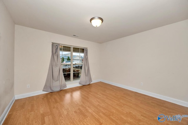 spare room featuring light hardwood / wood-style flooring