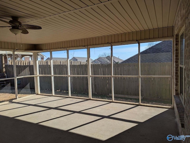 unfurnished sunroom featuring ceiling fan and wood ceiling