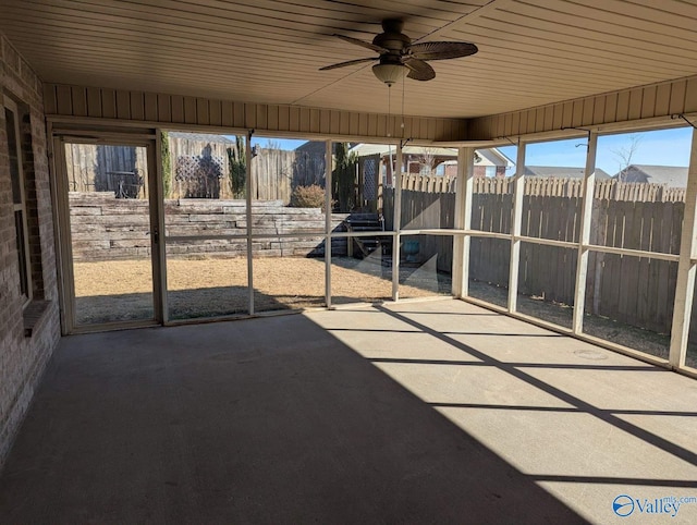 unfurnished sunroom with wood ceiling and ceiling fan