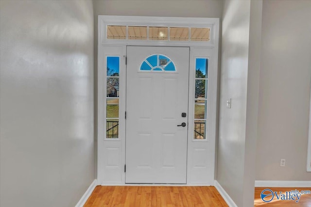 foyer entrance featuring baseboards and light wood finished floors