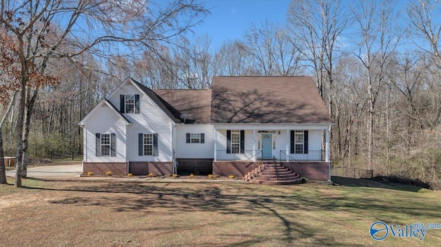 new england style home with a porch and a front yard