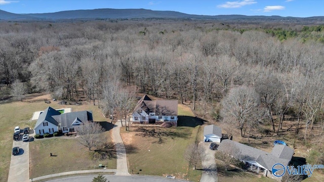 aerial view with a mountain view and a forest view