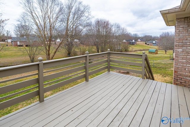 wooden terrace with a lawn