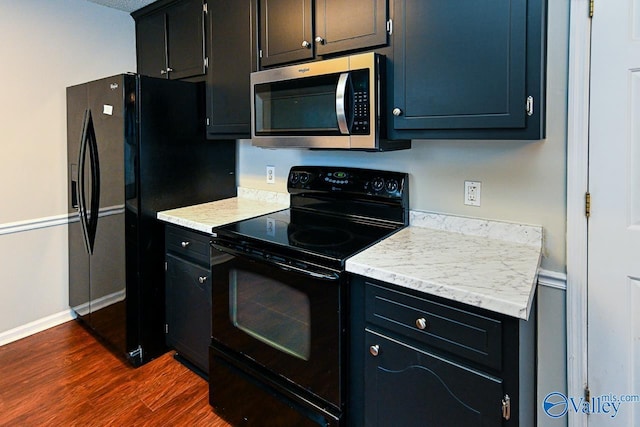 kitchen featuring dark hardwood / wood-style flooring and black appliances