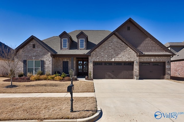 view of front facade featuring a garage, concrete driveway, and brick siding