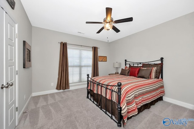 bedroom with carpet, visible vents, baseboards, and ceiling fan