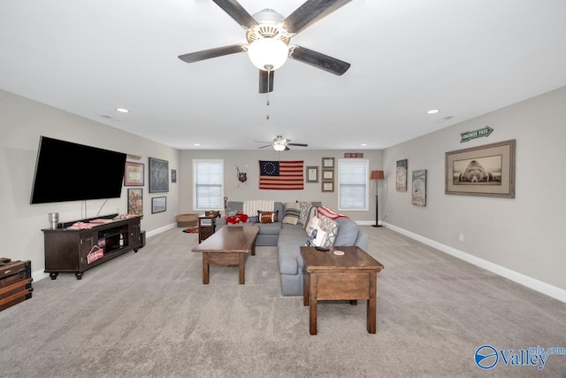 carpeted living area with baseboards and recessed lighting