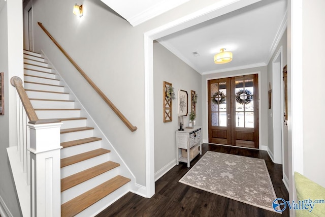 entryway featuring french doors, dark wood finished floors, ornamental molding, baseboards, and stairs