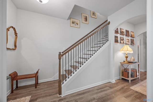 stairs featuring hardwood / wood-style flooring