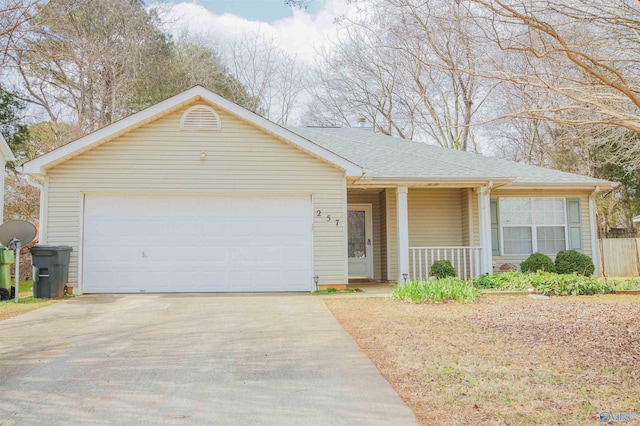 ranch-style home featuring an attached garage, covered porch, driveway, and roof with shingles