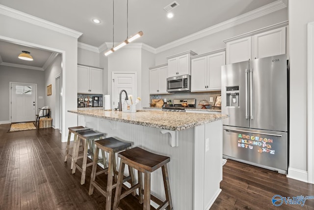 3015 Peevey Creek Ln, Owens Cross Roads, AL 35763 - kitchen with stainless steel appliances, dark wood-type flooring, a sink, a kitchen breakfast bar, and decorative backsplash