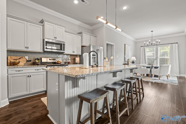 3015 Peevey Creek Ln, Owens Cross Roads, AL 35763 - kitchen featuring appliances with stainless steel finishes, backsplash, a center island with sink, dark wood-type flooring, and a kitchen breakfast bar