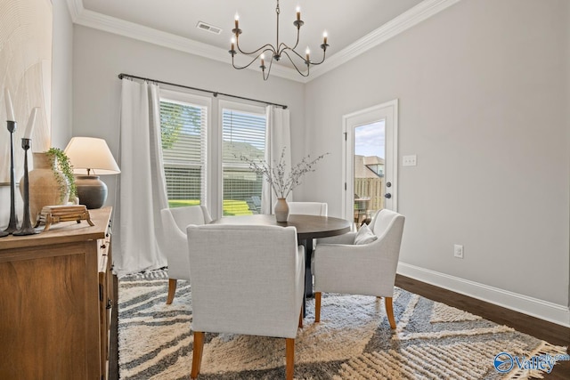3015 Peevey Creek Ln, Owens Cross Roads, AL 35763 - dining area with a chandelier, baseboards, crown molding, and dark wood finished floors