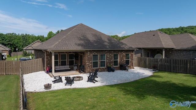3015 Peevey Creek Ln, Owens Cross Roads, AL 35763 - rear view of house featuring a patio, a fire pit, brick siding, and a shingled roof