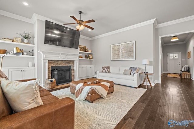 3015 Peevey Creek Ln, Owens Cross Roads, AL 35763 - living area with a ceiling fan, crown molding, hardwood / wood-style floors, a stone fireplace, and baseboards