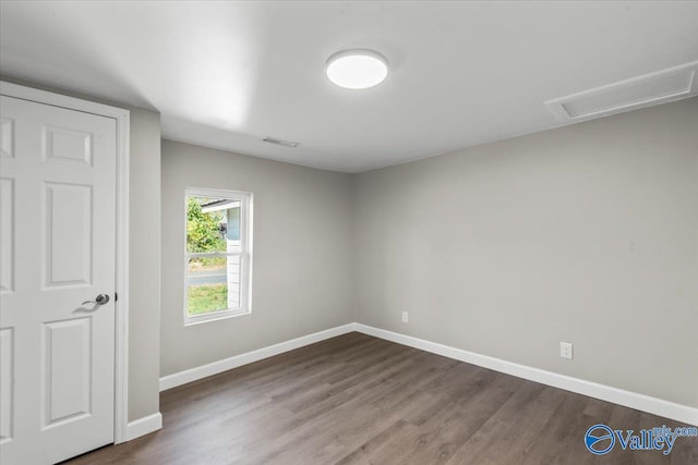 empty room with hardwood / wood-style flooring