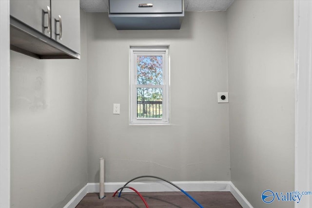 laundry area with electric dryer hookup, washer hookup, and cabinets