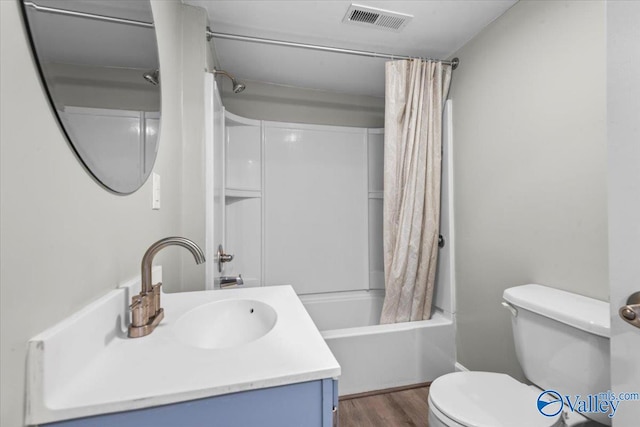 full bathroom with toilet, hardwood / wood-style flooring, shower / bath combination with curtain, and vanity