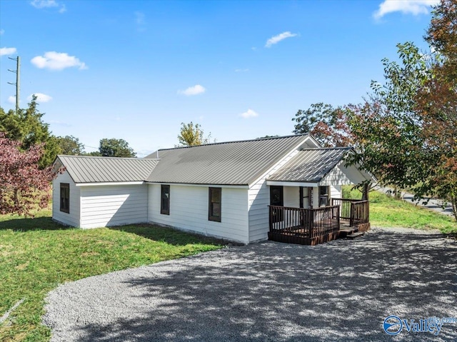 view of front of home featuring a front yard and a deck