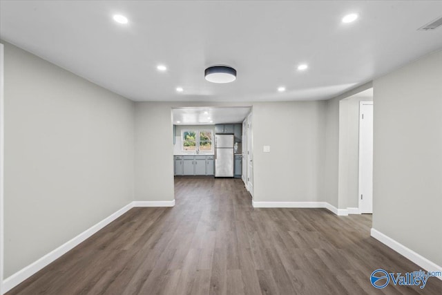 unfurnished living room with dark hardwood / wood-style flooring