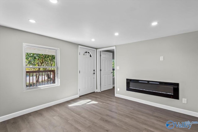 unfurnished living room featuring wood-type flooring