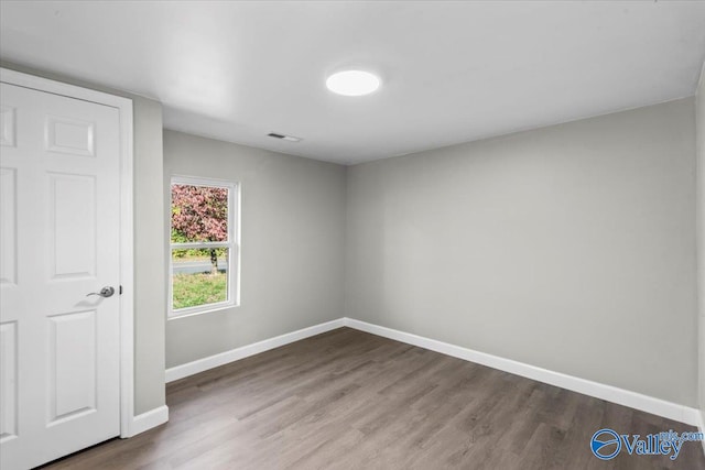 empty room with wood-type flooring