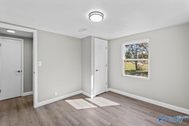 unfurnished bedroom featuring wood-type flooring