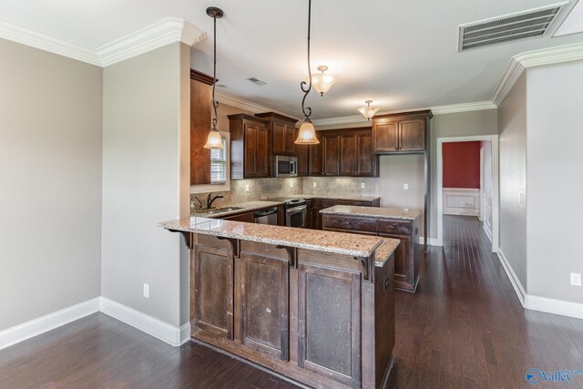 kitchen with stove, tasteful backsplash, light stone counters, kitchen peninsula, and dark wood-type flooring