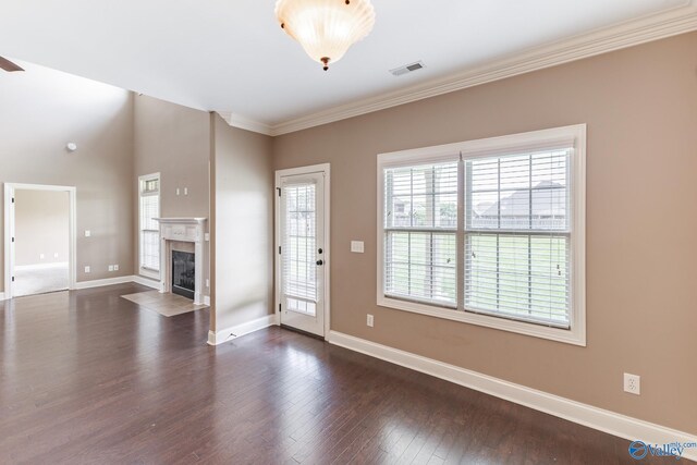 unfurnished living room with dark hardwood / wood-style floors, a healthy amount of sunlight, and a fireplace